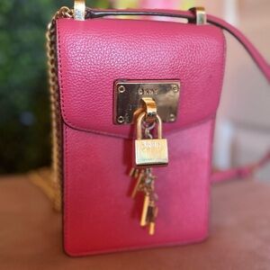Hot pink DKNY crossbody satchel with gold accents